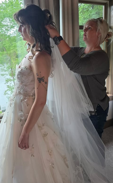 Colleen placing a veil on a bride