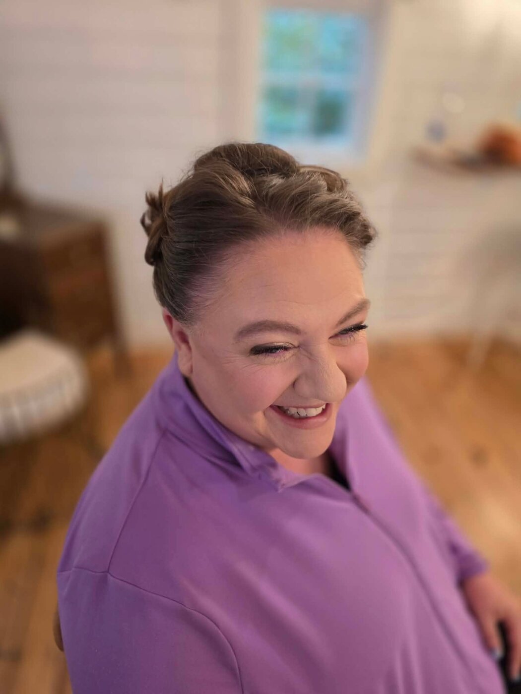 Smiling client with an elegant braided updo