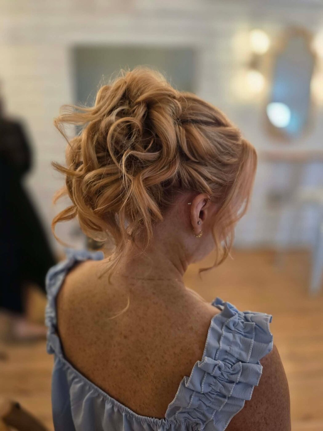 Classic bridal updo with face-framing detail