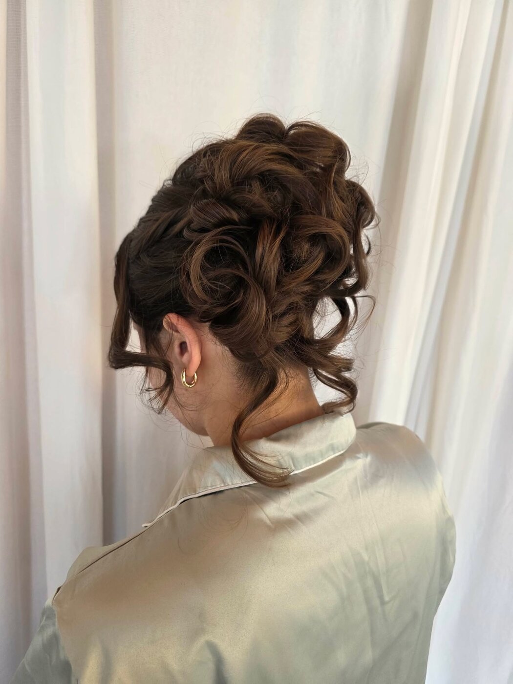 Classic bridal updo with face-framing detail