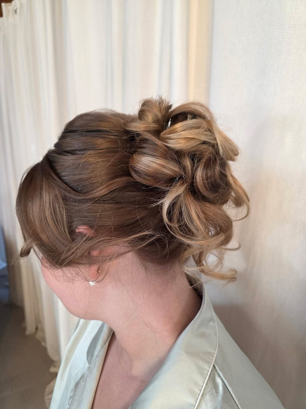 Elegant bridal updo with soft romantic curls