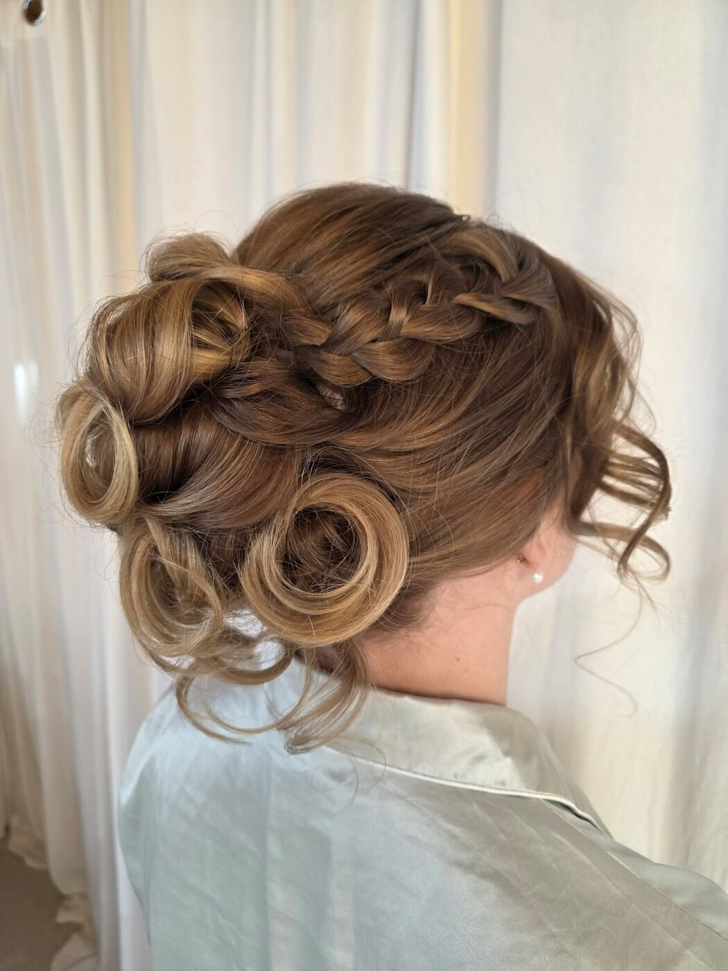 Elegant bridal updo with soft romantic curls