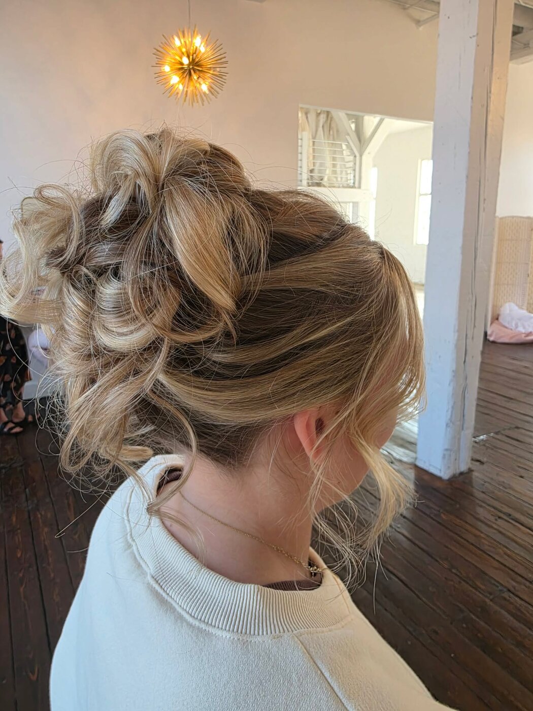 Classic bridal updo with face-framing detail
