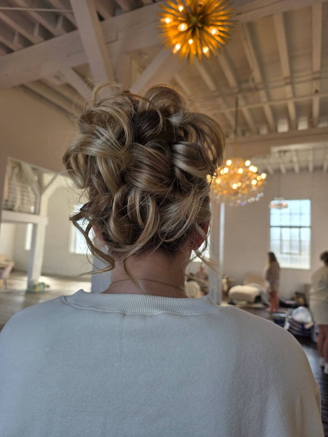 Classic bridal updo with face-framing detail