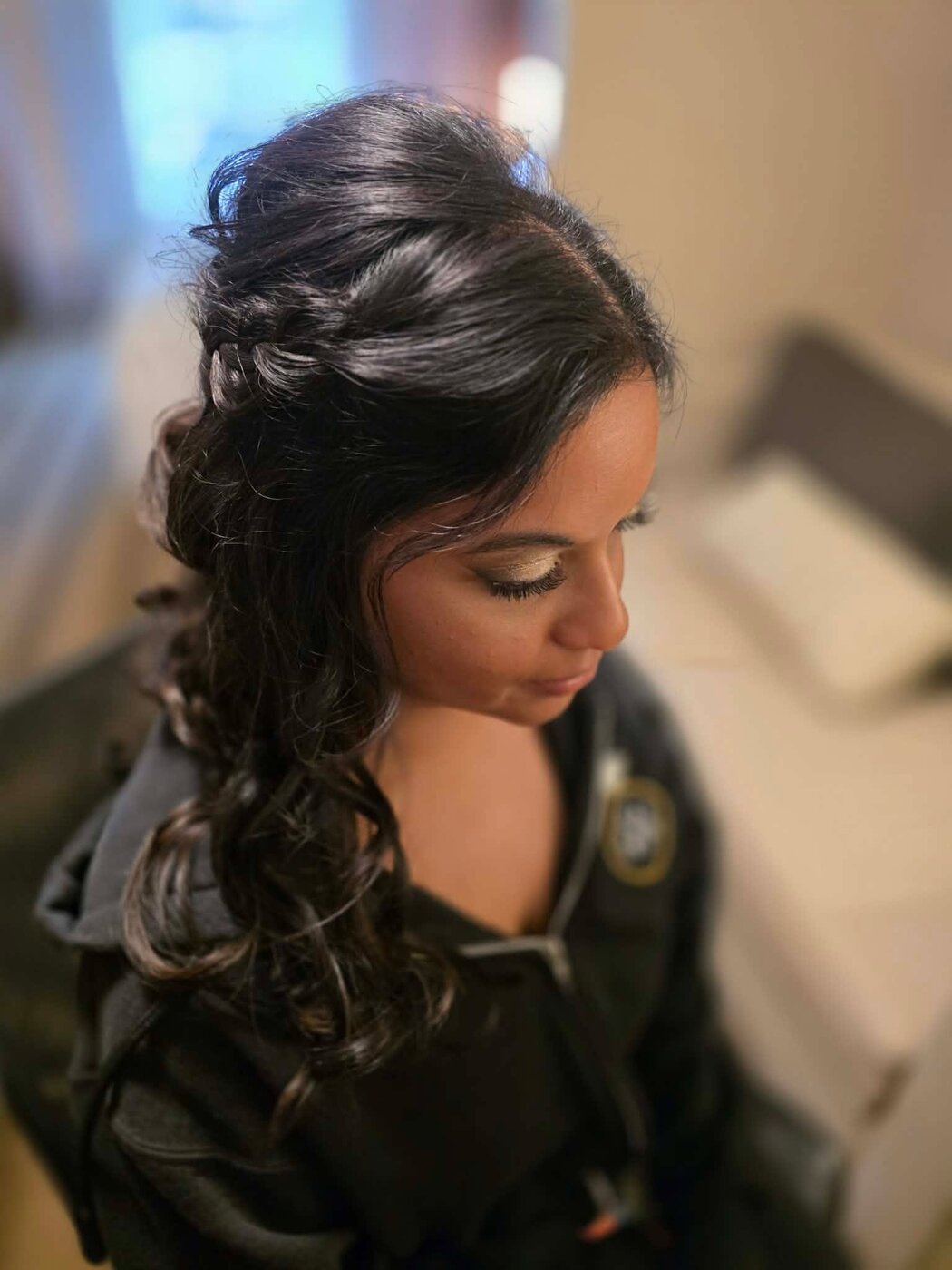 Bride with soft side-swept waves and a braided accent